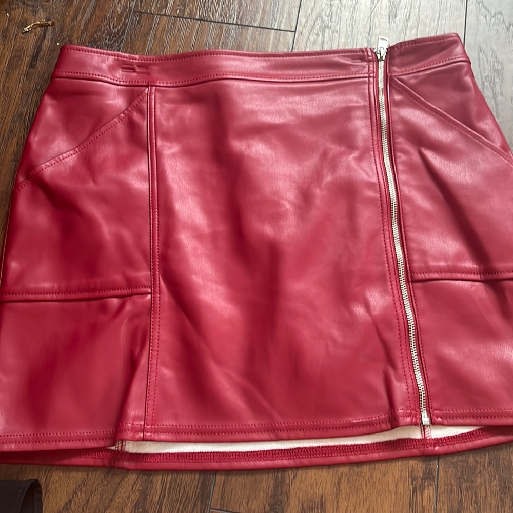 Red leather skirt. Size 14. NWT. Clip marks from hanger. Should relax some.